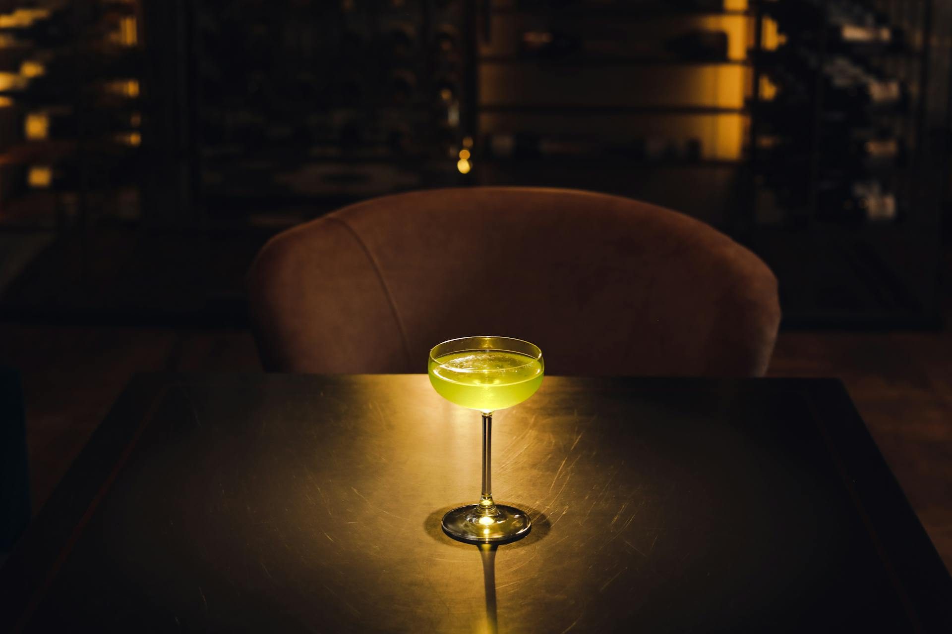 Dark bar with a backlit cocktail on table