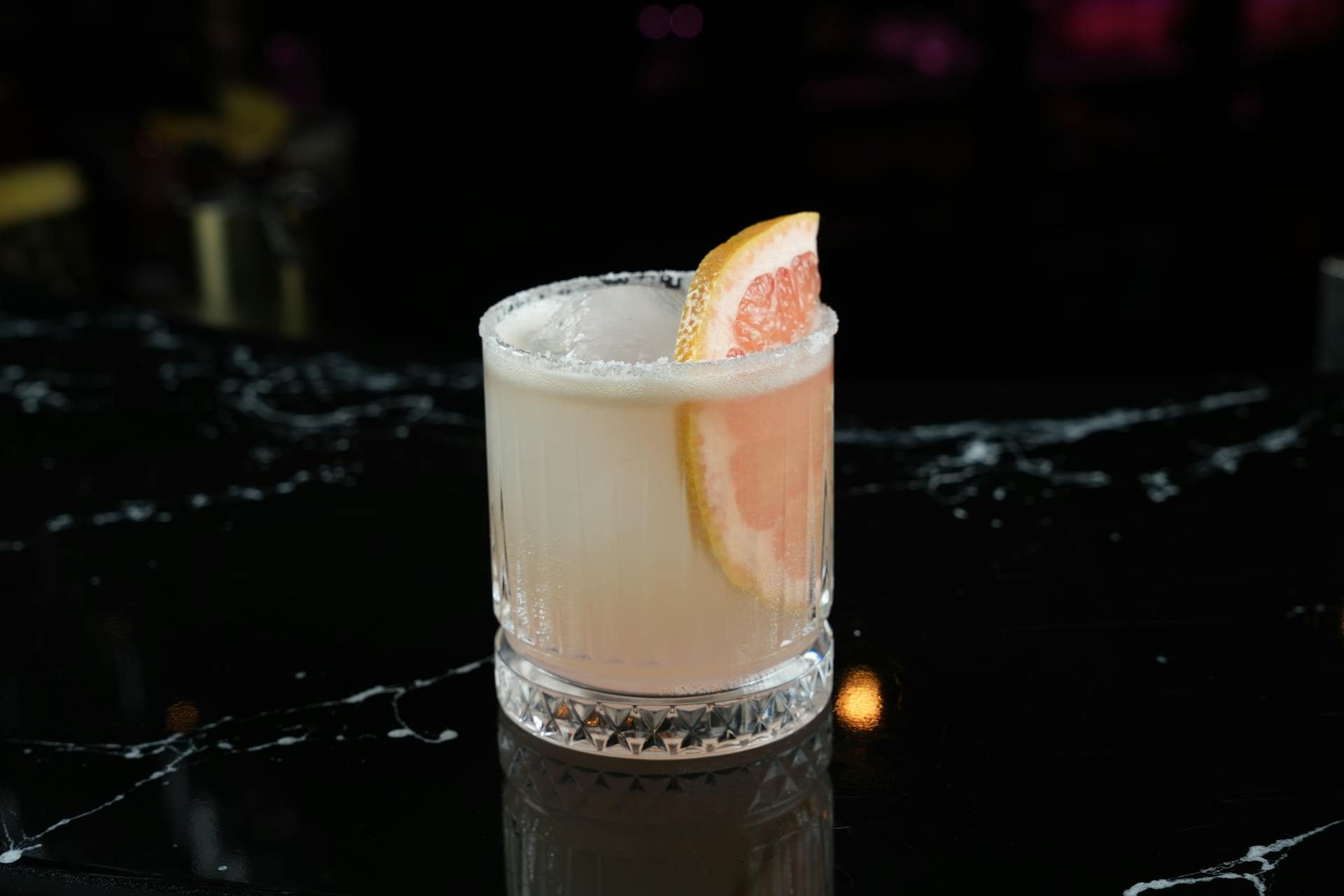 Salt rimmed cocktail glass with grapefruit wedge