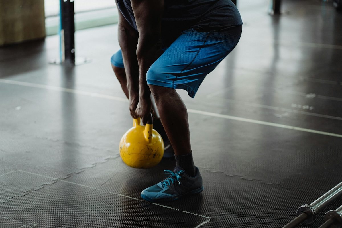 man with yellow kettlebell