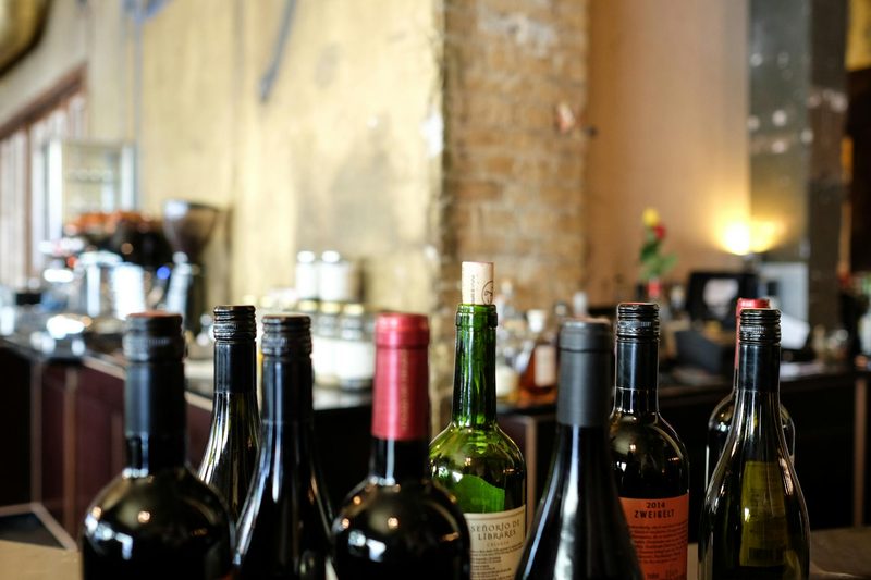 Multiple wine bottles sitting on surface