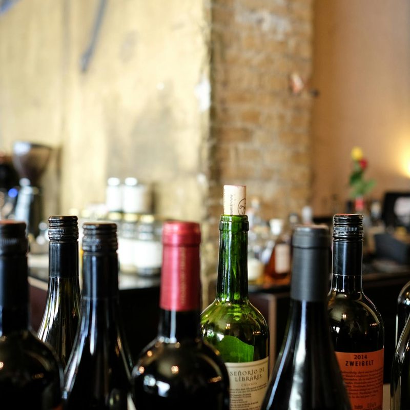 Multiple wine bottles sitting on surface