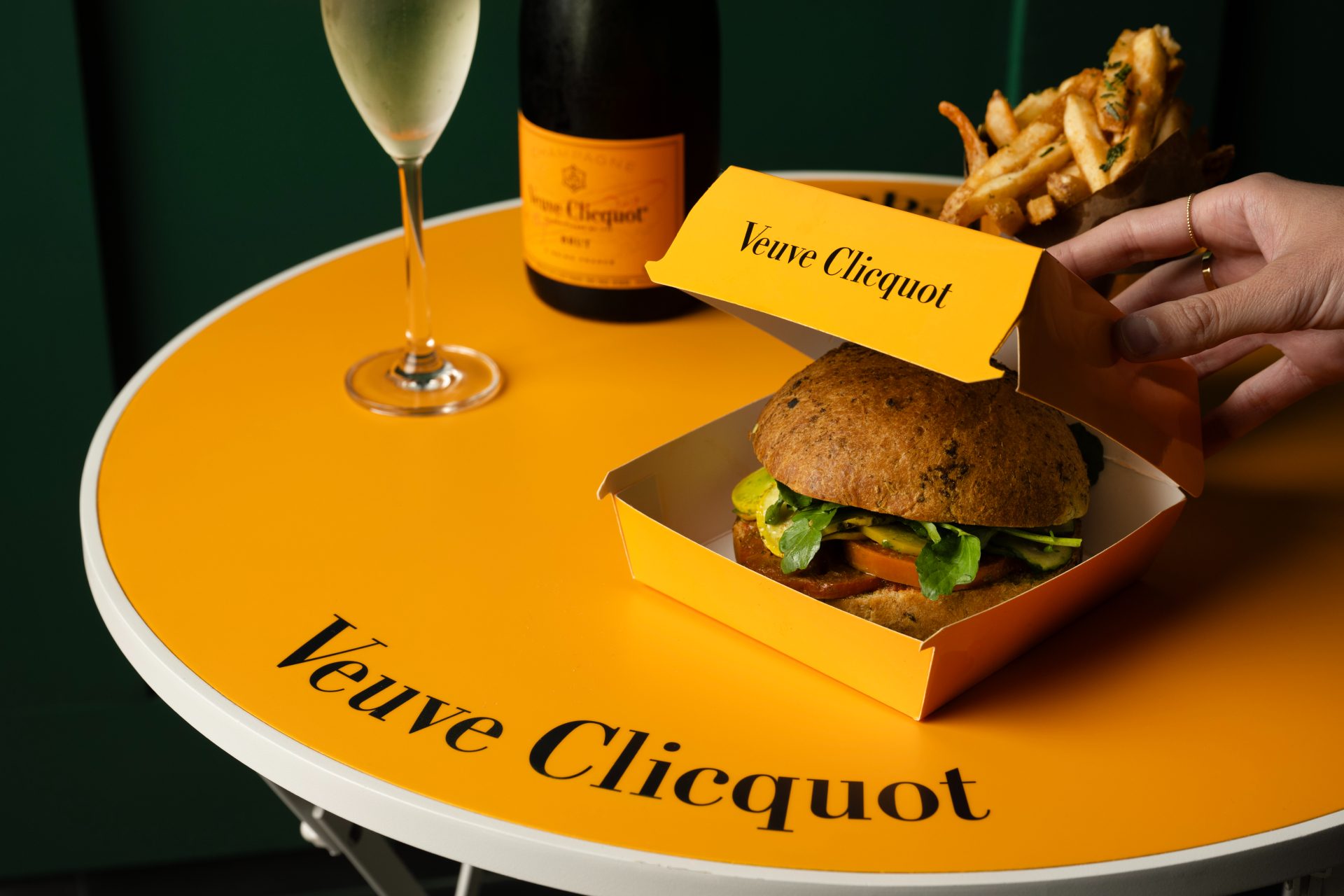 veggie burger in yellow takeout container