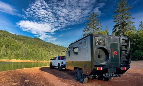 A Roam Resilient Baja Edition overland trailer parked by a lake.