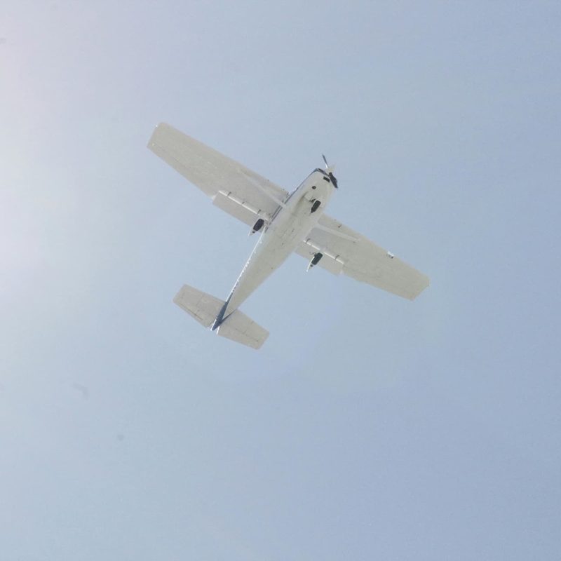 White airplane flying in a blue sky