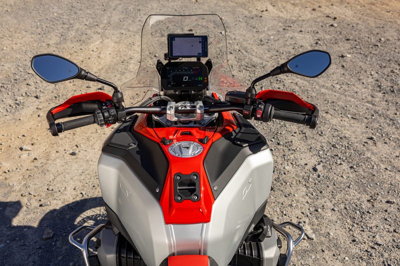 2025 BMW R 1300 GS Adventure riders cockpit parked on a dirt road.