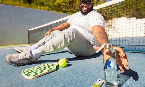 Liquid IV in bottle outdoors while playing tennis - Prime Day deal