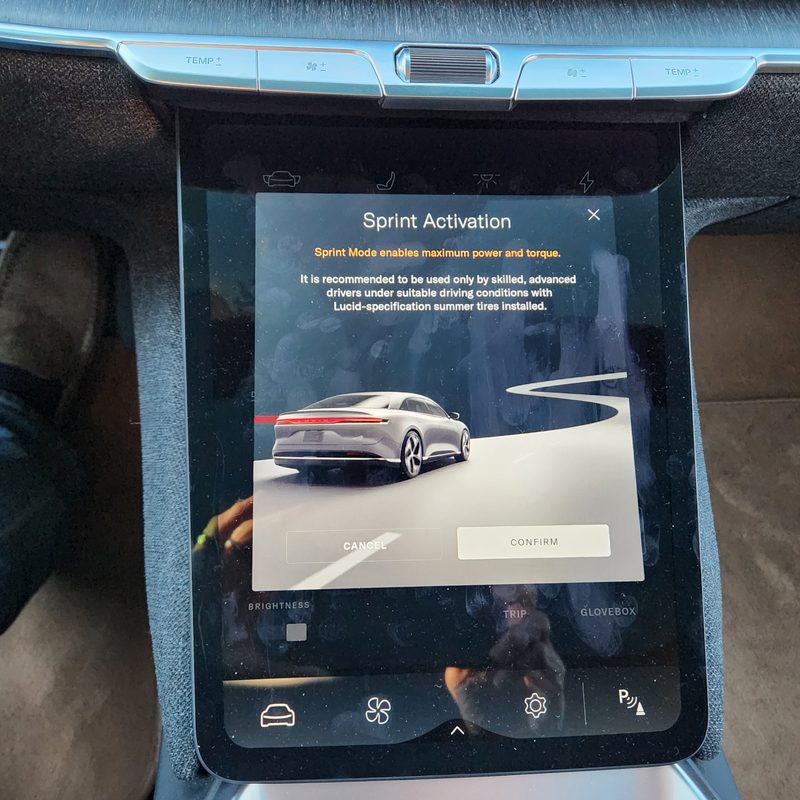 Lucid Air Touring EV switching to Sprint mode with a screenfull of disclaimers and disclosures.