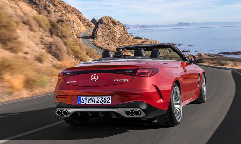 Mercedes-AMG CLE 53 4MATIC+ Cabriolet driving away on an ocean-side highway.