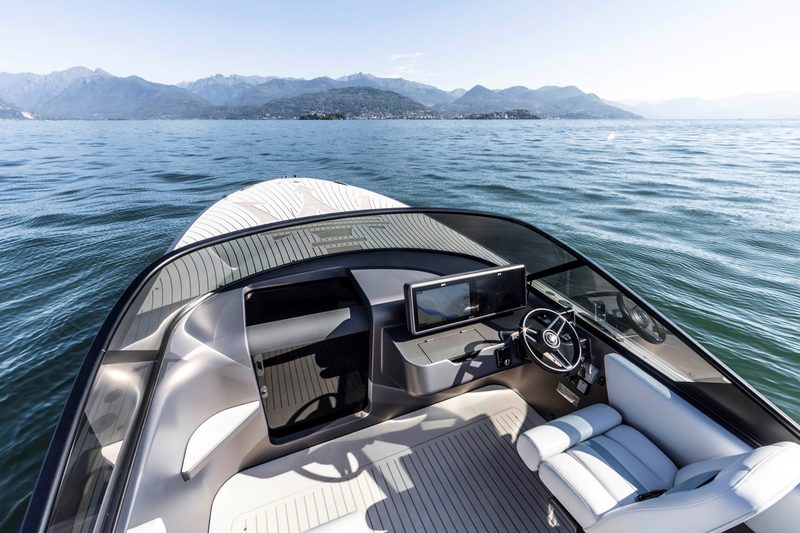 Open cockpit and a view of the day berth of a Maserati TRIDENTE luxury all-electric powerboat at Lake Maggiore.