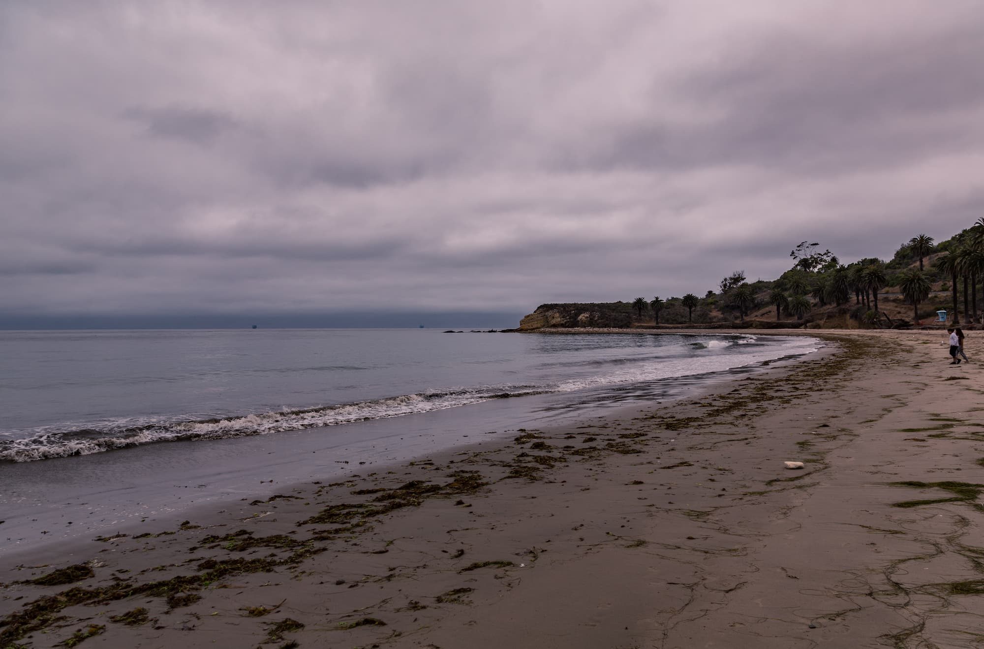 ocean and sand during a gloomy day