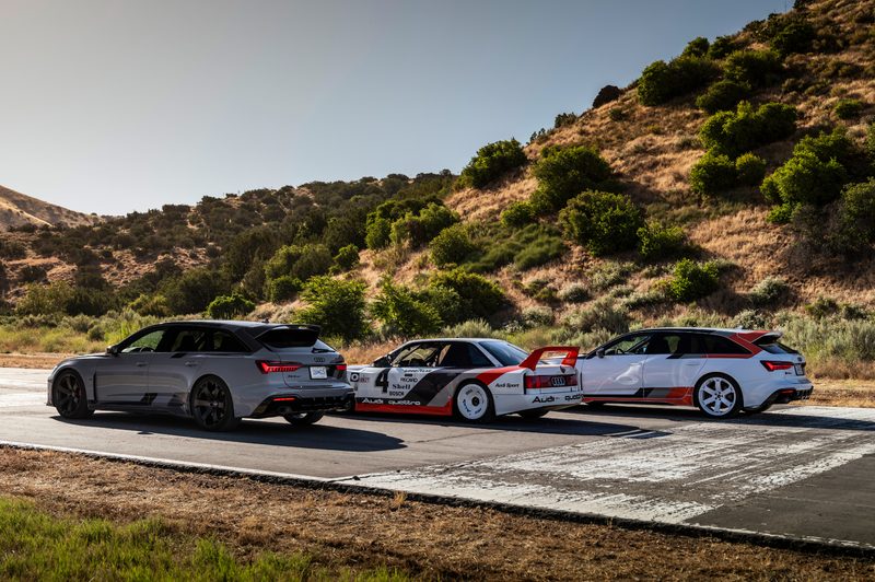 Two limited edition 2025 Audi RS 6 Avant GTs flanking a 1989 Audi 90 quattro IMSA GTO racing car.