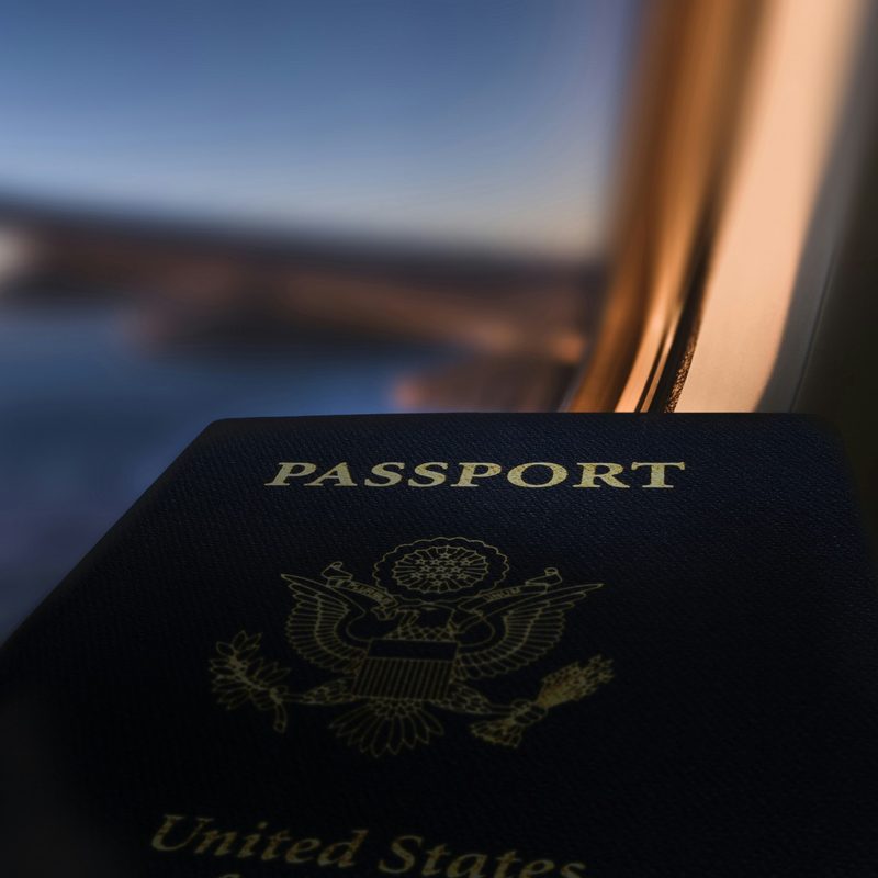 Passport in front an airplane window