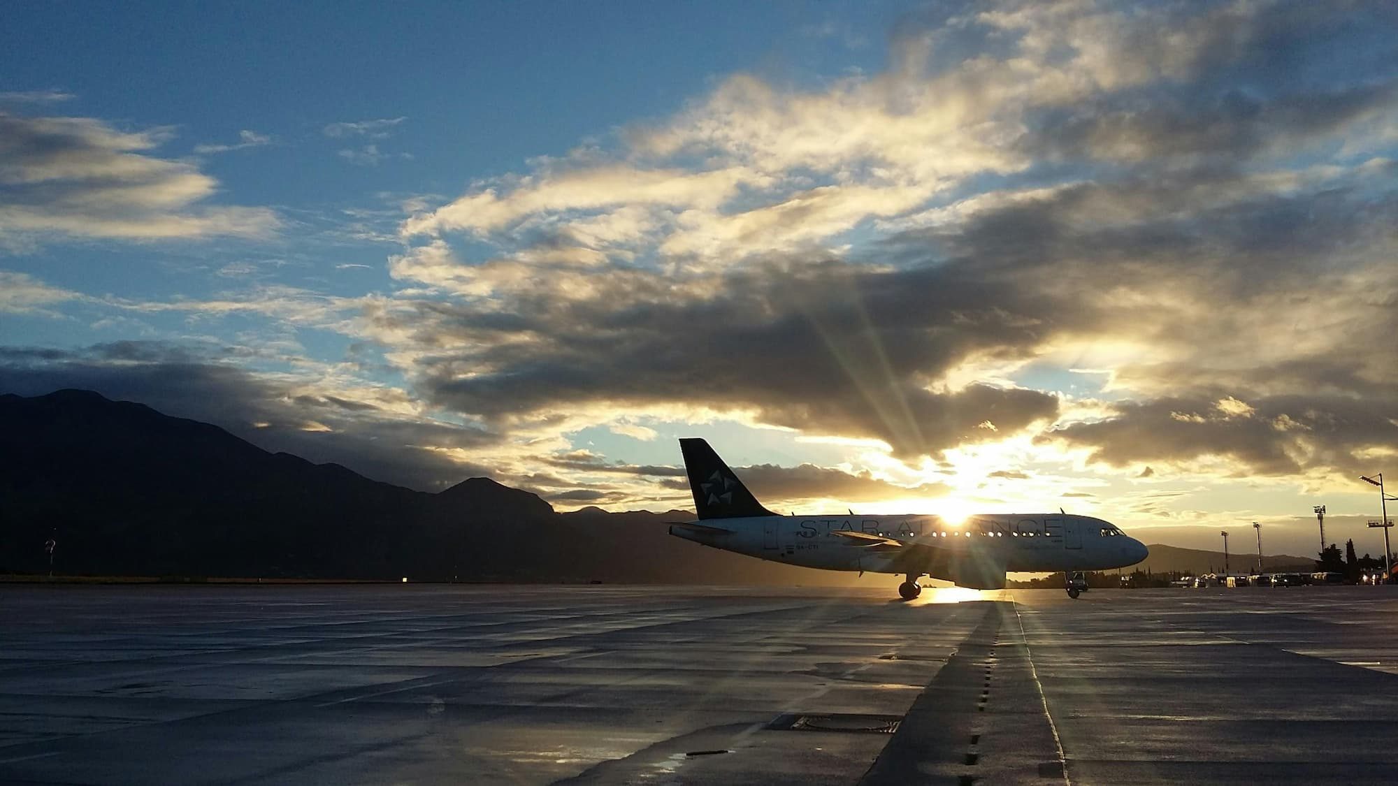 silhouette of an airplane outside during sunset