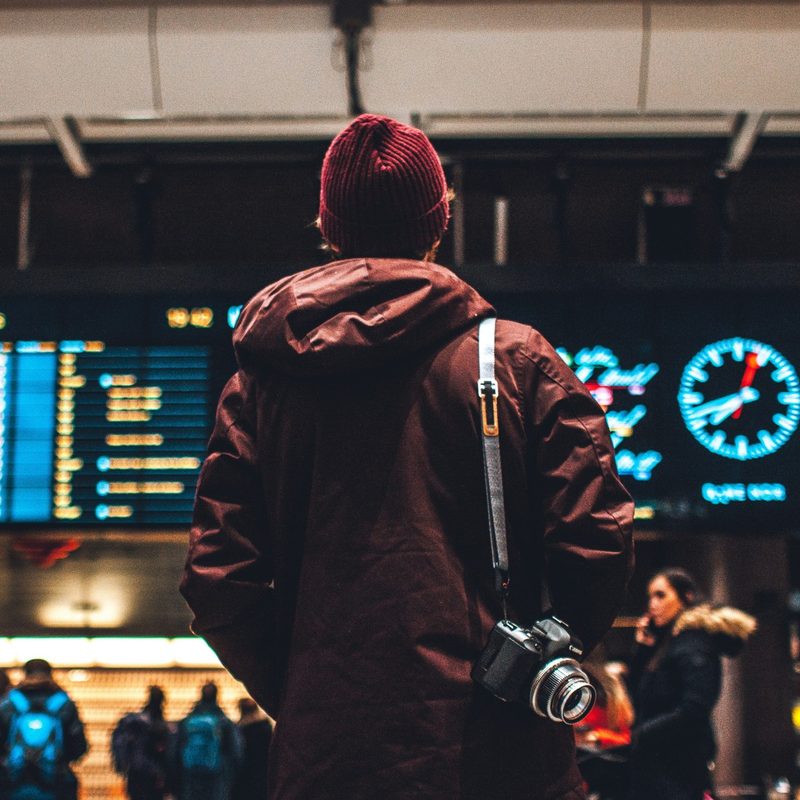 Passenger at airport flight board