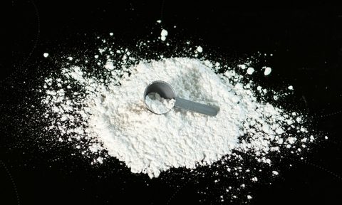 Spilled creatine with a scoop spoon