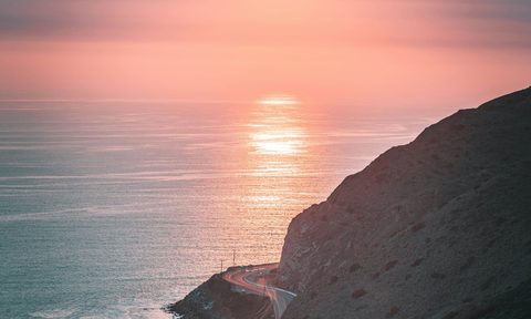 The sun setting over the ocean
