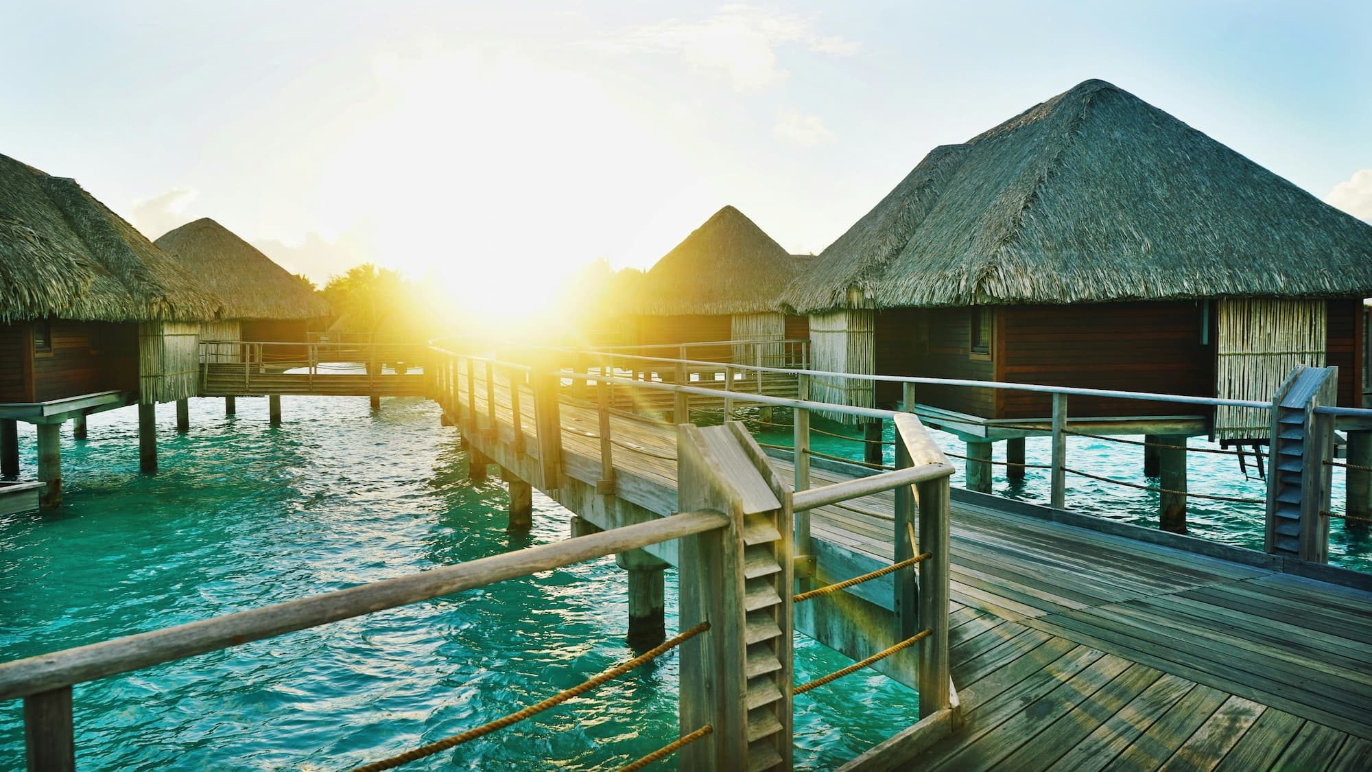 brown wooden dock between houses in water