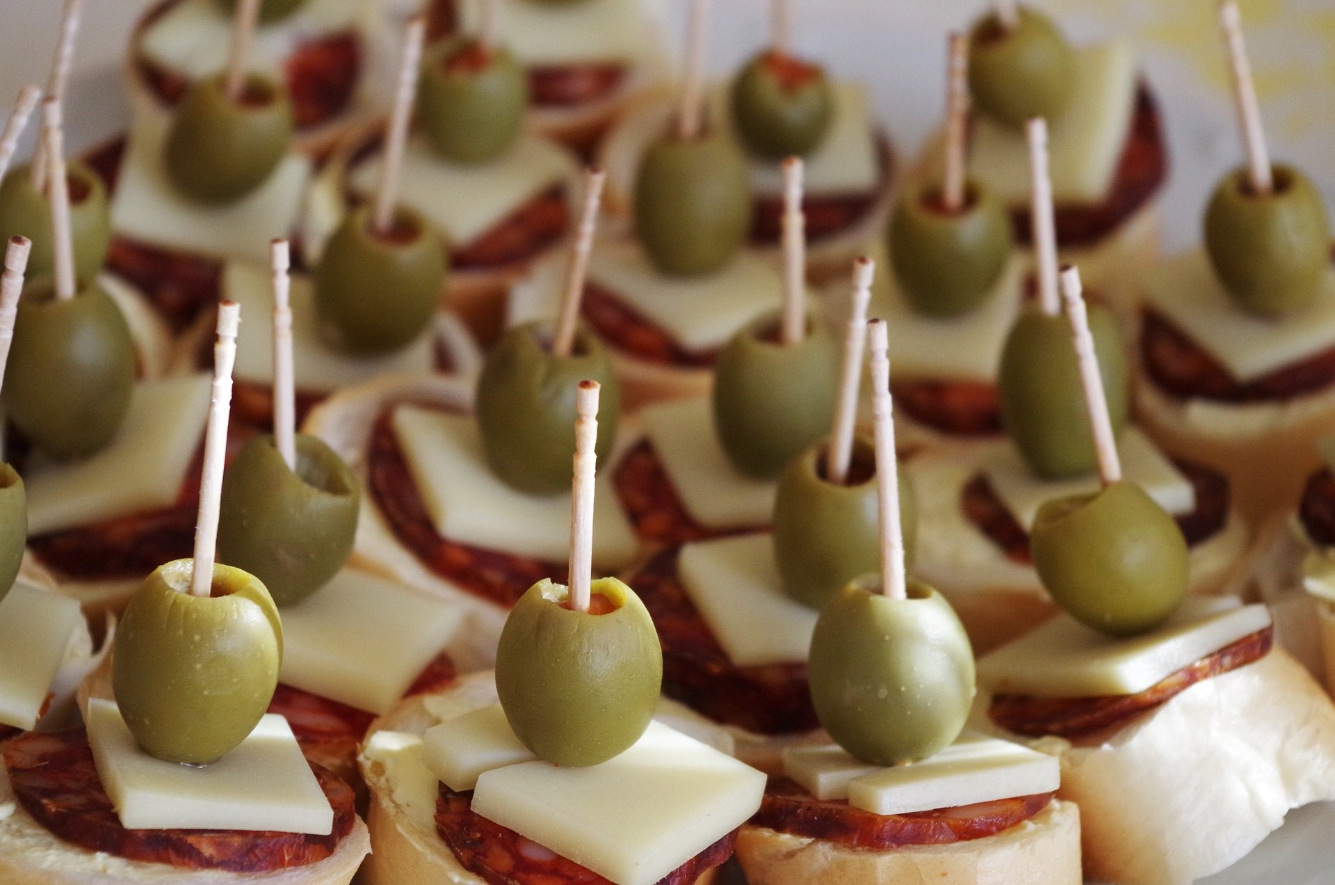 Salami, cheese, green olive canapes