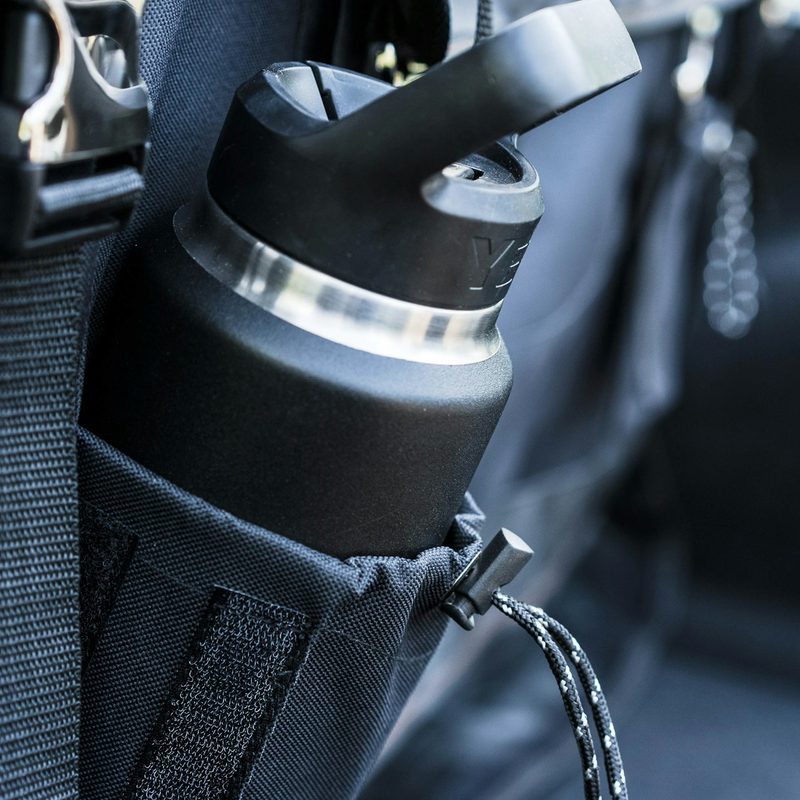 a yeti water bottle in the side pocket of a black bag
