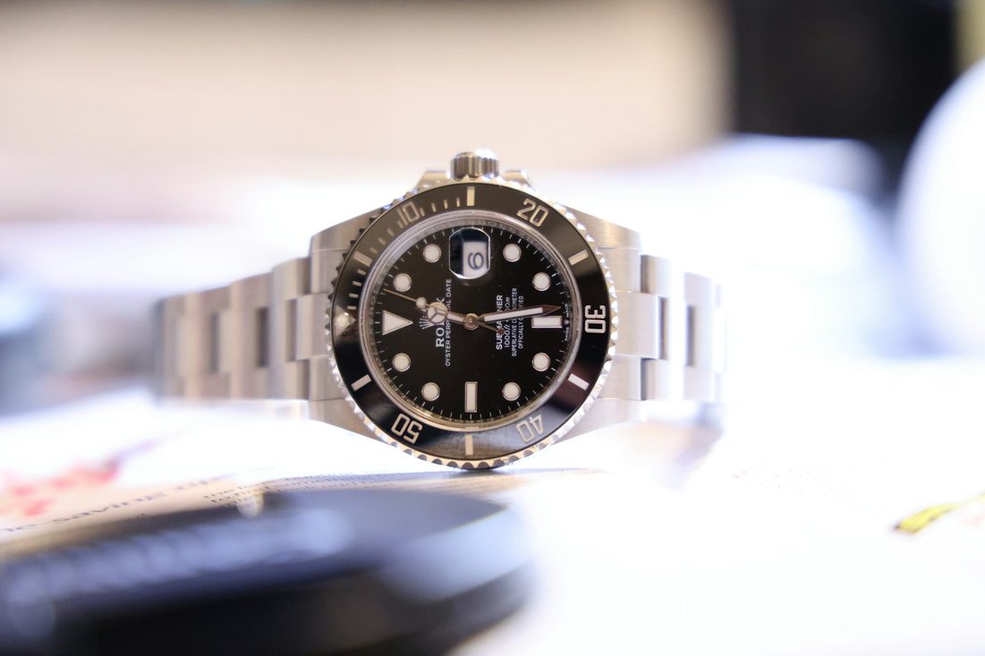 Rolex watch sitting on table