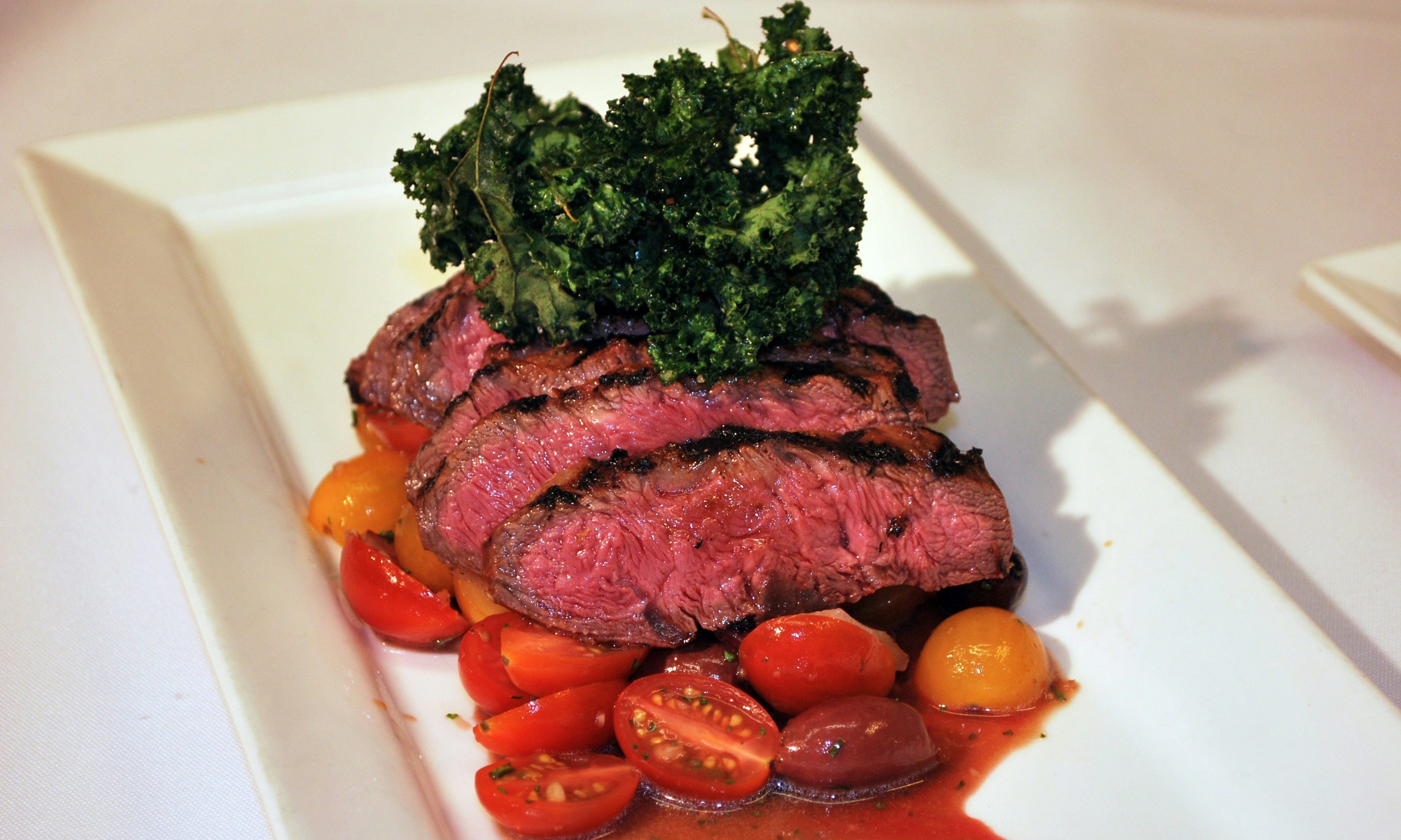 Sliced steak on a white plate