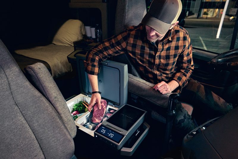 Man pulling a steak out of an EcoFlow Glacier portable refrigerator.