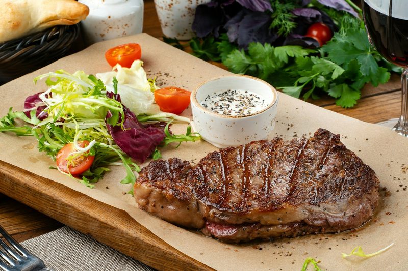 Steak and salad on cutting board