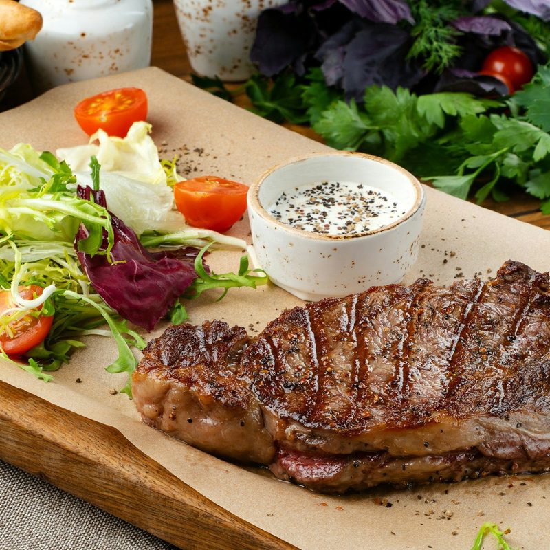Steak and salad on cutting board