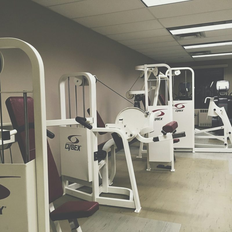 Leg machine at gym for leg curl seated