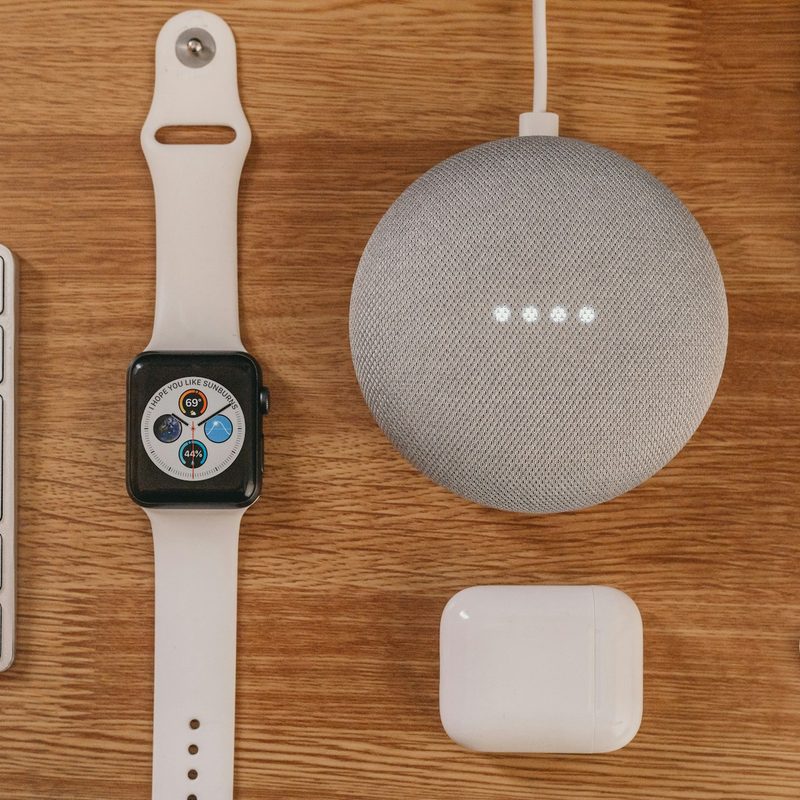 Apple Watch sitting on desk with other devices