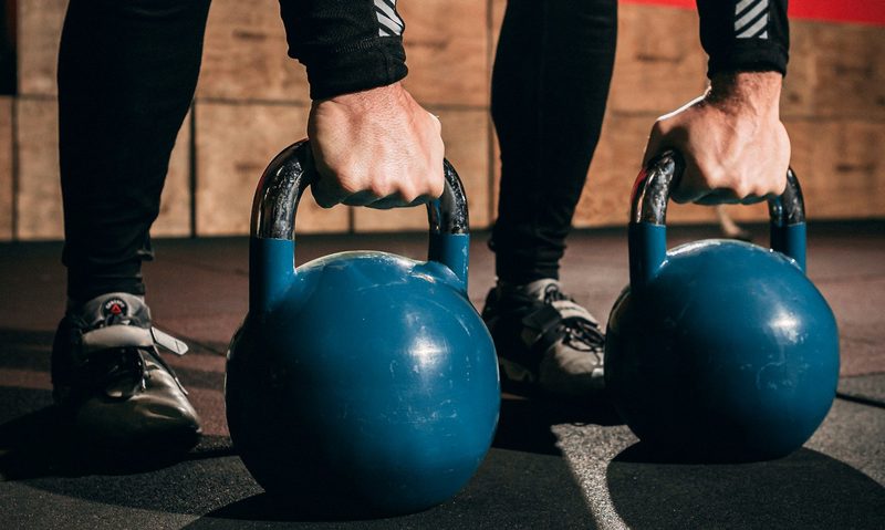 Doing kettlebell swings in the gym