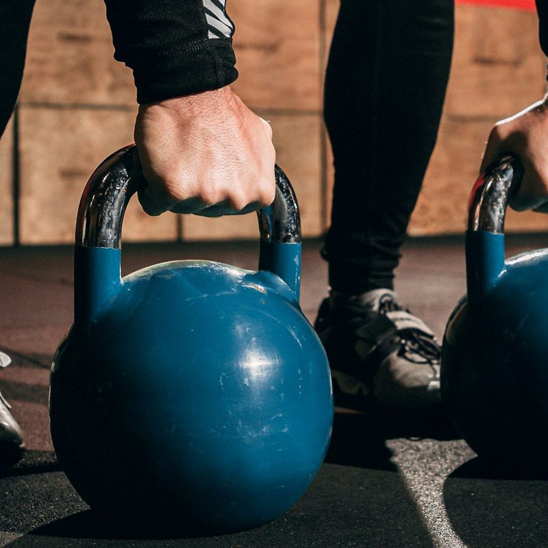 Doing kettlebell swings in the gym