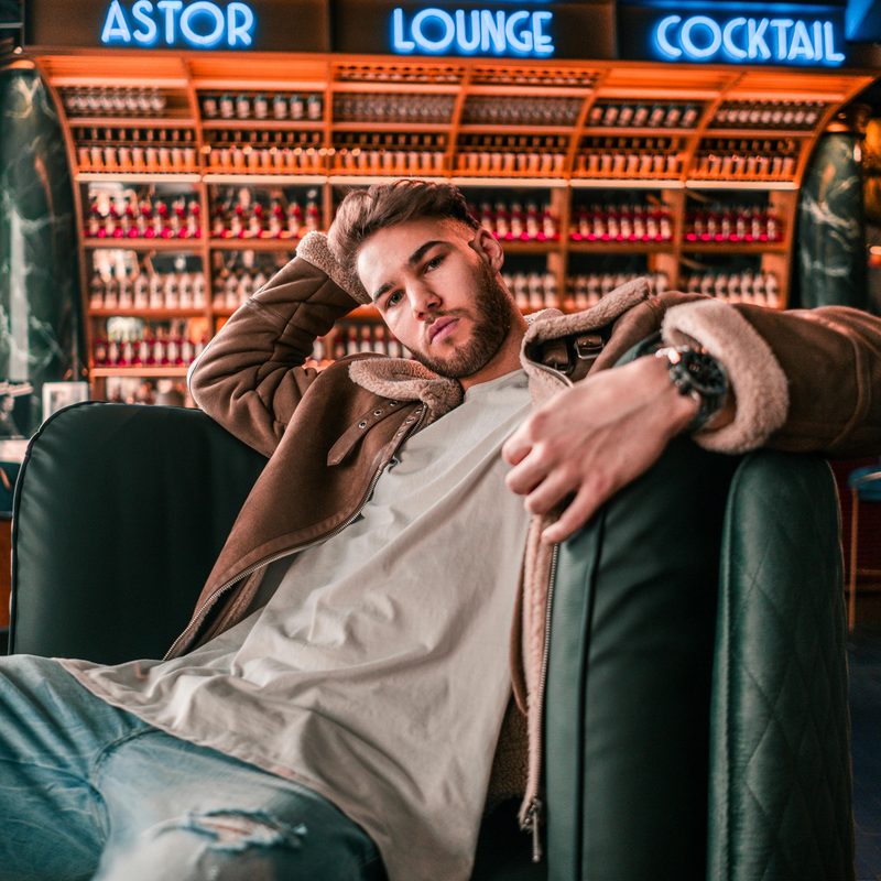 Man on a couch in a leather jacket