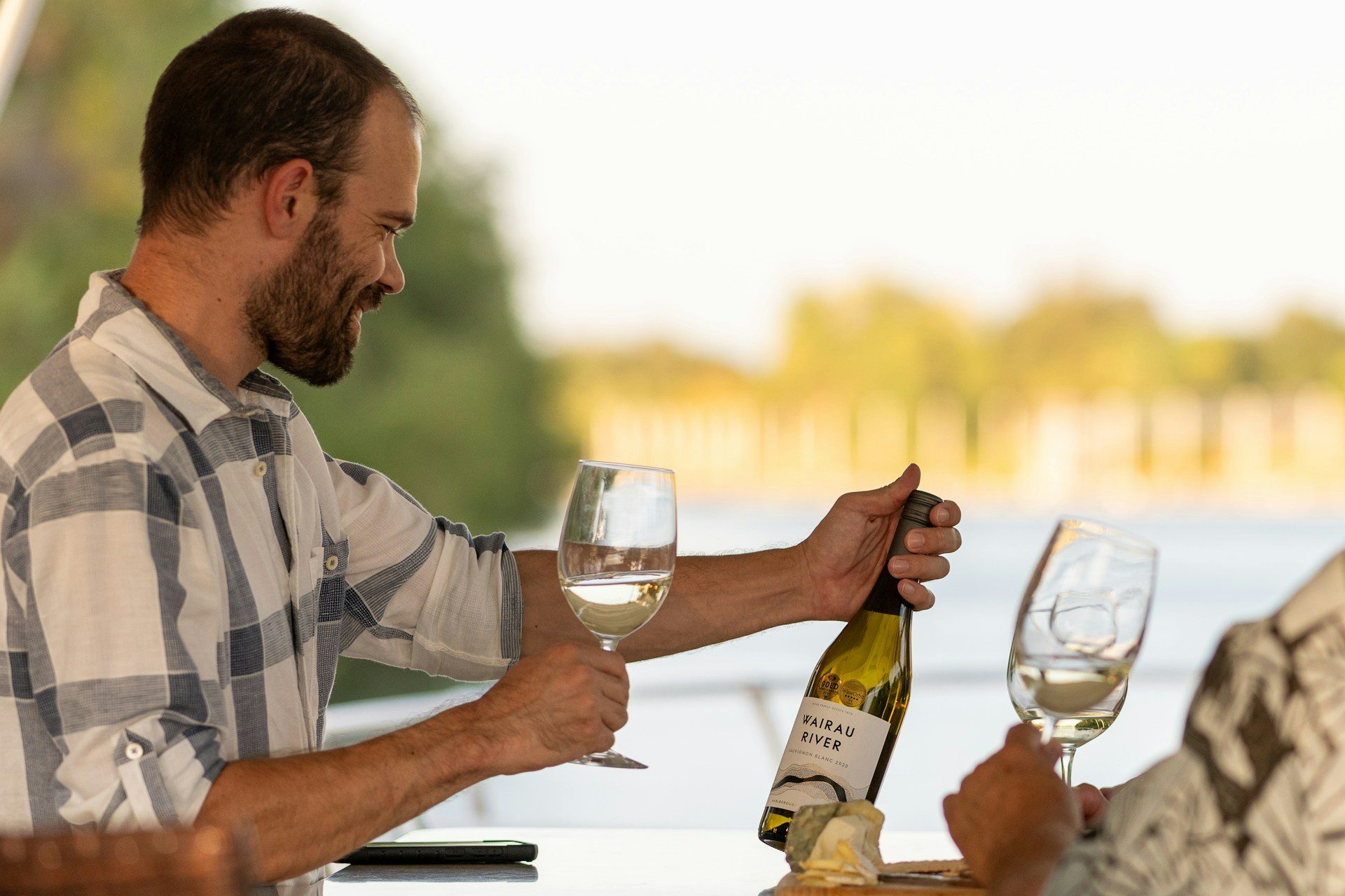 Man looking at a wine bottle