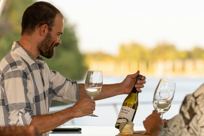 Man looking at a wine bottle