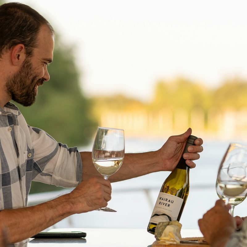 Man looking at a wine bottle