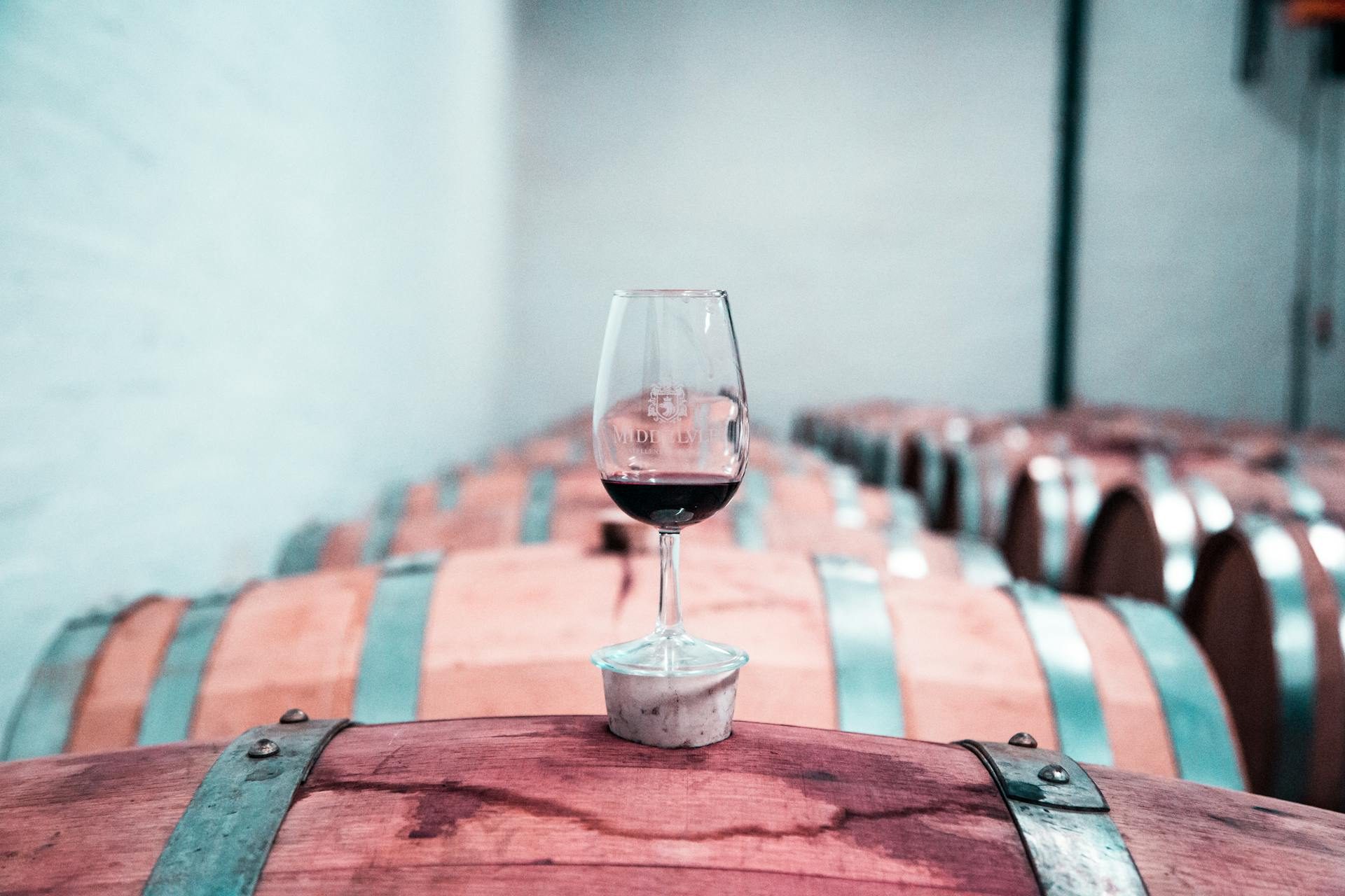 Wine glass filled with small amount of red wine