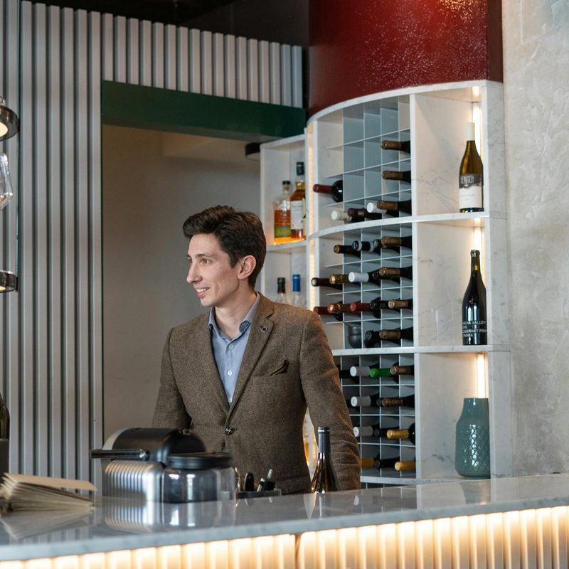 Man standing in a winery in blazer