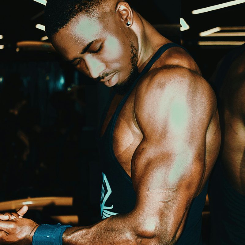 Man close-up flexing arm muscles triceps biceps