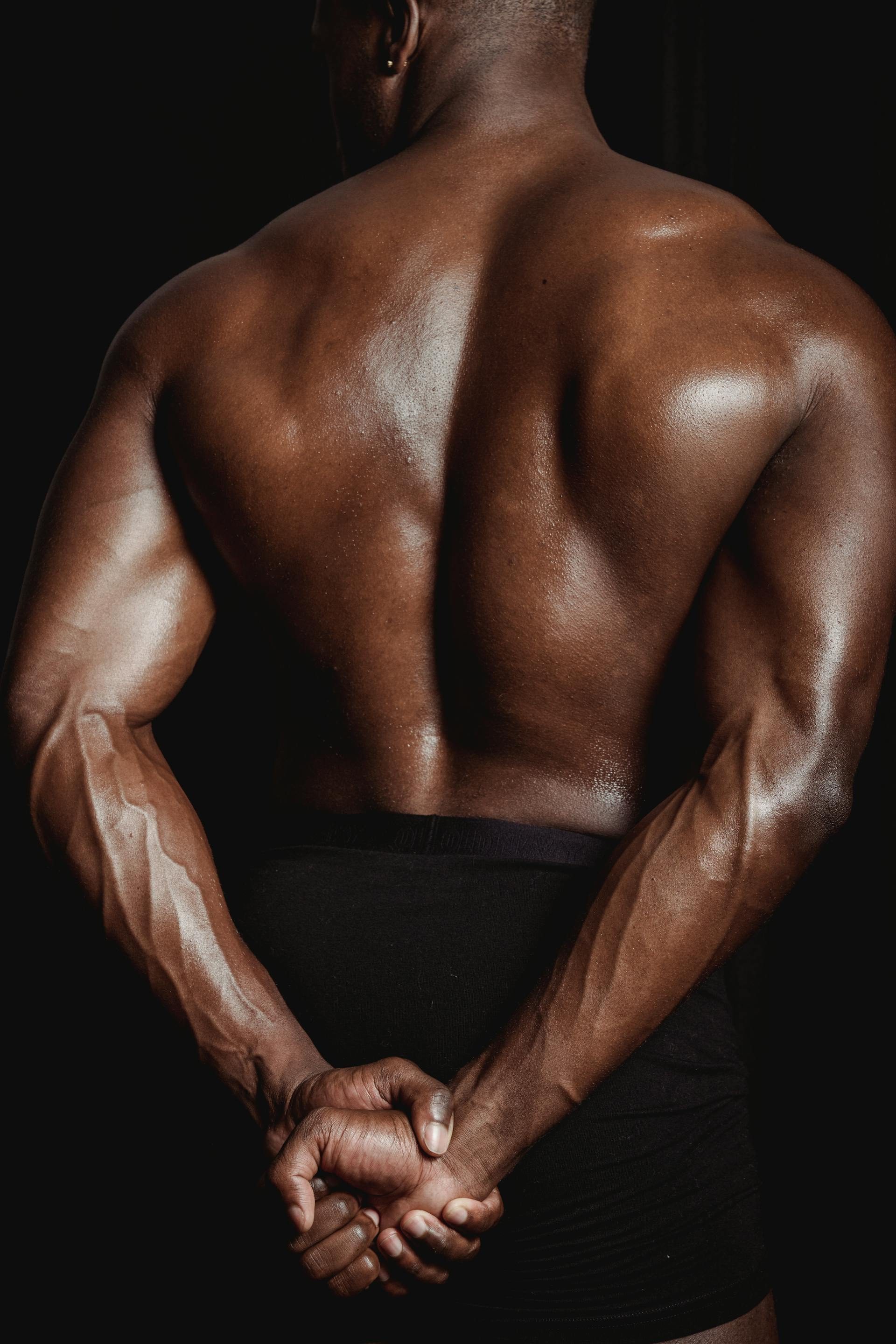 pexels-mike-jones-shirtless muscular man close up of muscles flexing triceps