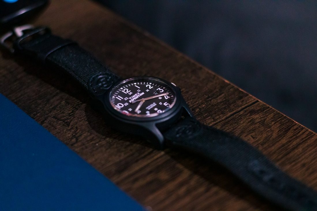 close up of watch on wooden table