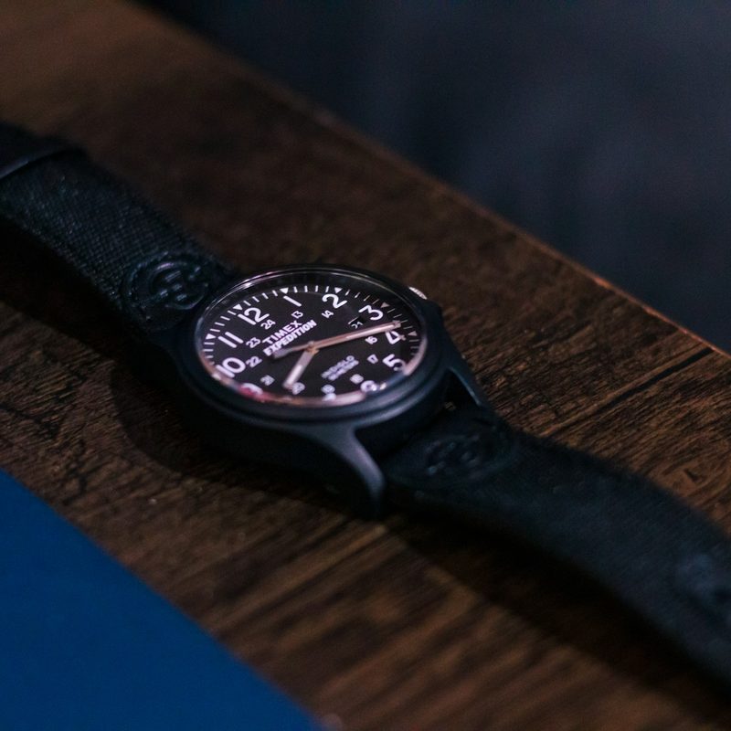 Close-up of a watch on a wooden table