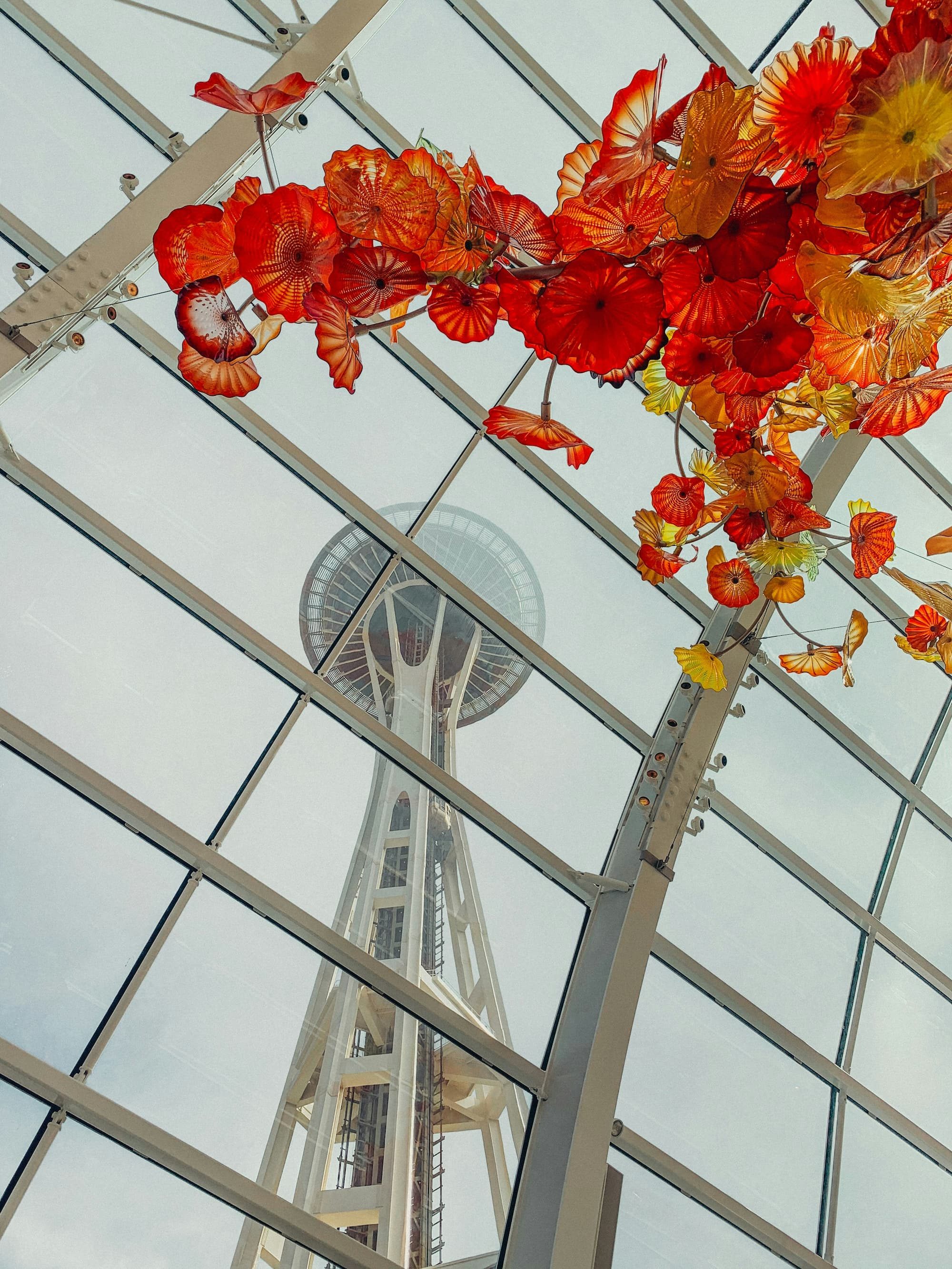 tall building with a glass roof and a tall tower in the background