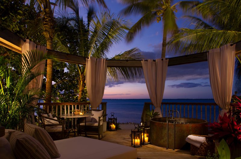 A sun setting at a beach in a tropical environment