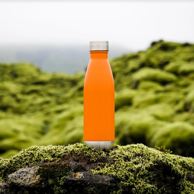 Orange water bottle sitting outside