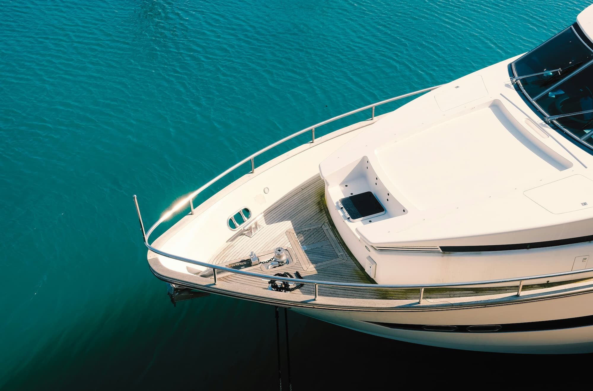 white yacht on body of water during daytime