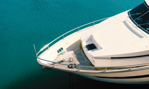 white yacht on body of water during daytime