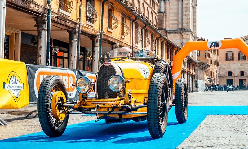 1925 Bugatti Type 35 - 3 parked on a blue carpet with a palace in the background direct front view.