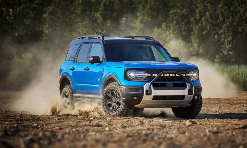 2025 Bronco Sport Badlands with Sasquatch off-road performance package driving in dirt right front three-quarter view.