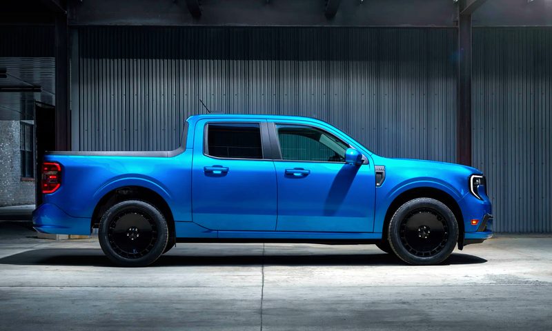 2025 Ford Maverick Lobo street performance truck right profile view parked on gray concrete inside a gray metal building.